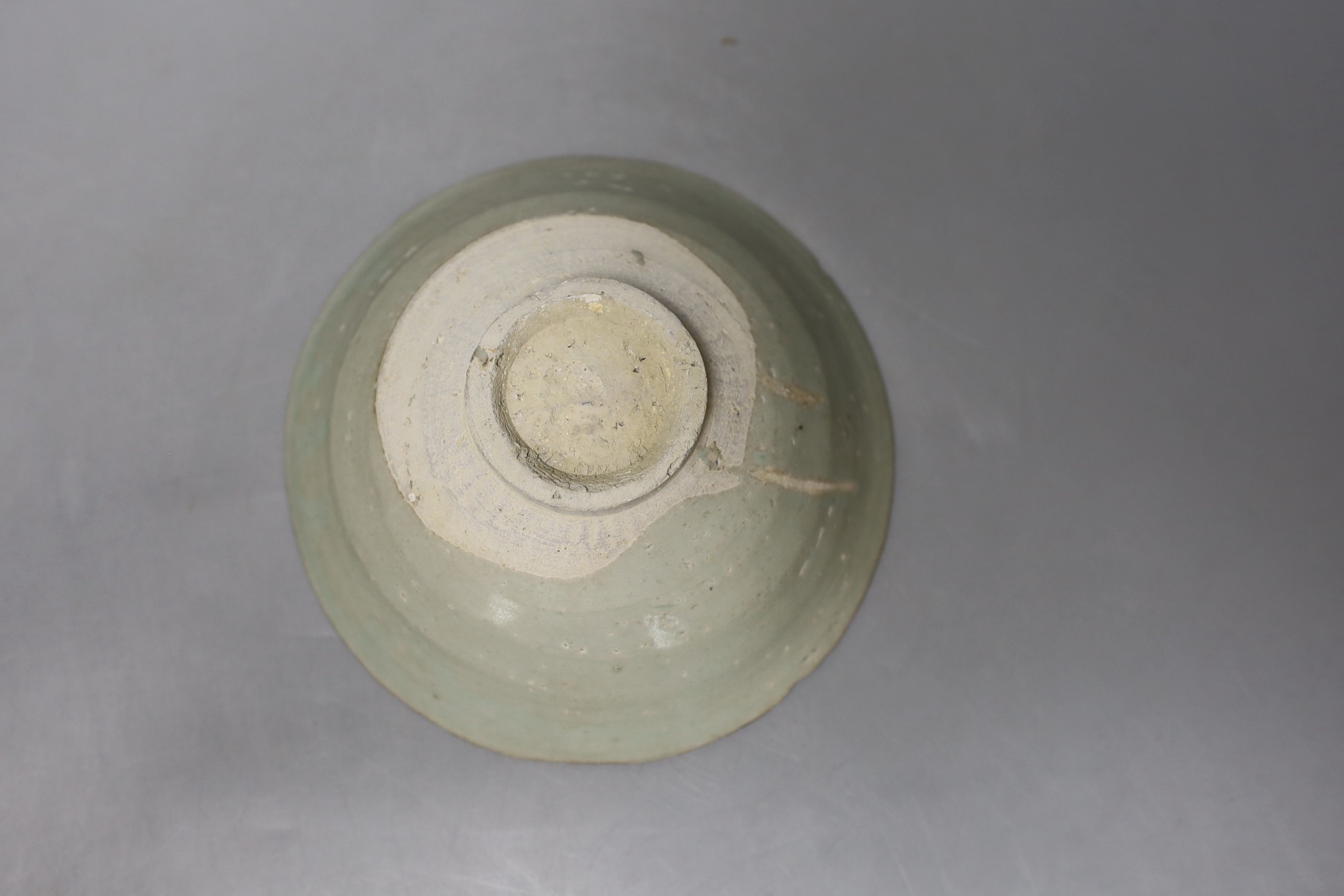 A Chinese incised celadon shipwreck bowl, Song/Yuan dynasty - 16.5cm diameter